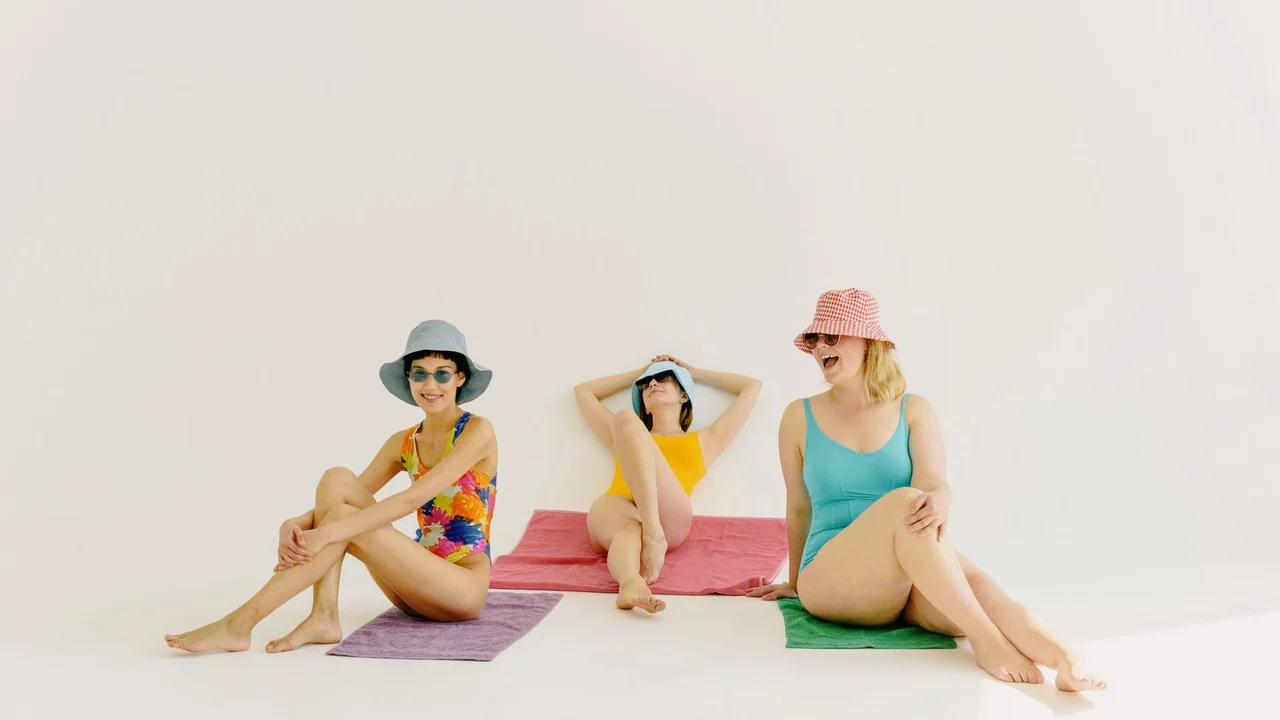 Three people wearing sun hats and sunglasses