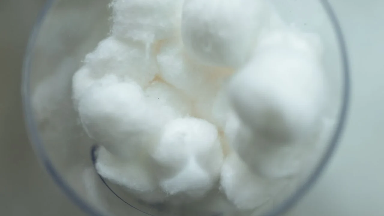 White cotton balls in a clear glass