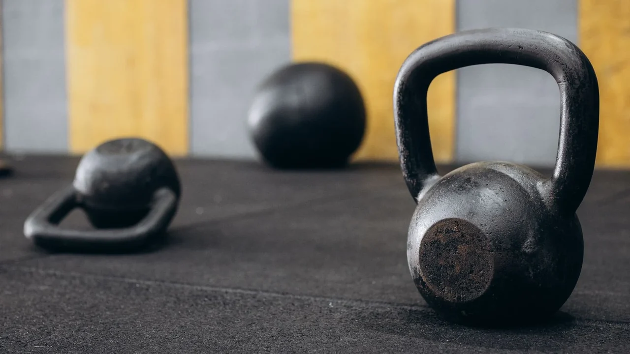 A black kettlebell on a gym floor